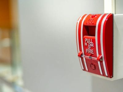 Fire alarm switch on the wall Red fire alarm switch on concrete wall in office building. Industrial fire warning system equipment for emergency.